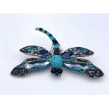 A kitch costume jewellery dragonfly brooch set with coloured crystals in turquoise and blues.