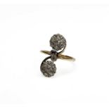 An unusual Edwardian gold ring with scrolling cross-over clusters set with old cut diamonds 3.