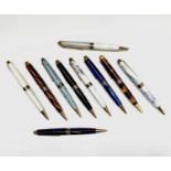 Ten ballpoint pens, each has gold plated mounts and a variety of tubes in wood and acrylic, each