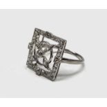 An unusual white gold or platinum 1920s ring diamond set with a propeller in a square 4.7gm