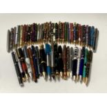 A large collection of fountain and ballpoint pens, including cloisonne