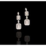 A pair of elegant and glittering 18ct white gold diamond earrings each with two graduated