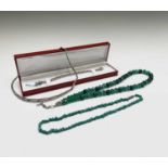 A silver necklace, a silver bracelet, a necklace with malachite beads, a turquoise necklace and a