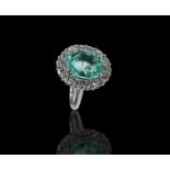 An exceptional 6.45ct Paraiba Tourmaline ring of the finest electric blue the oval stone set in