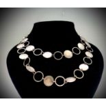 A Cornish craft silver necklace by Christine Farrington with alternating discs and rings length 92cm