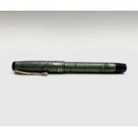 An Onoto Minor fountain pen by Thomas De La Rue in green mesh with Warranted 14ct Nib the plunger