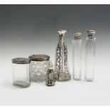 Four cut glass toilet jars each with silver lid and one other, damage