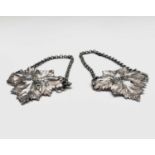 A pair of silver wine labels 'Port & Sherry' in the form of vine leaves by Charles Reilly and George