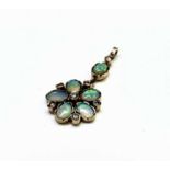 A fine Victorian-style pentamerous flowerhead gold pendant, each petal an oval opal separated by