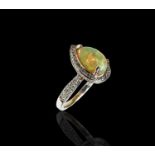 An 18ct white gold ring set a pear shape opal and many small diamonds 4.8gmCondition report: Size