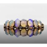 A 9ct gold bracelet set with seven graduated opals 11.8gmCondition report: Approx length 18.5cm.