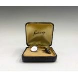 A pair of mother of pearl cuff links in Harrods box