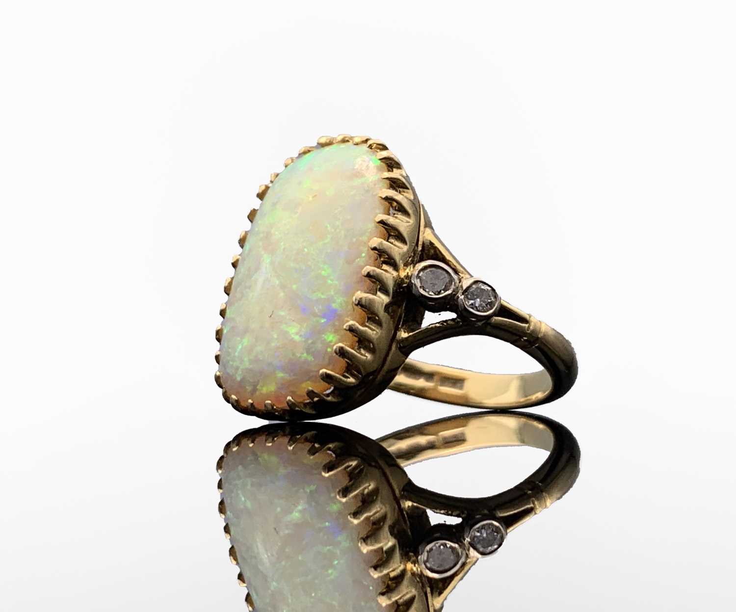 An 18ct gold ring set a large rounded rectangular opal, each shoulder set a pair of diamonds 7. - Image 2 of 4