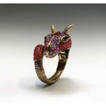 An fabulous kitch mythical beast hinged bangle.Non-precious metal set with red and irridescent