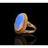A 14ct gold ring set with an opal in rope-twist borders 6gmCondition report: The opal is fully