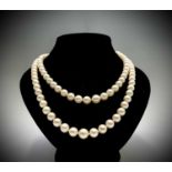 An impressive double strand pearl necklace with 18ct white gold (un-marked) clasp set with diamonds