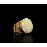 A 9ct gold opal ring with collet setting and engraved Celtic strapwork 8.3gmCondition report: The