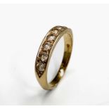 An 18ct gold ring set a line of seven diamonds 2.9gm