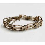 A 9ct gold 4 bar link bracelet with padlock clasp 12.6gm