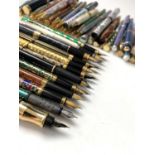 A large collection of fountain and ballpoint pens, including cloisonne