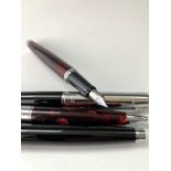 A Sheaffer 300 red fountain pen and matching ballpoint together with a similar pair in black