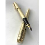 A Scheaffer Prelude Signature gold plate fountain pen with diamond square pattern and a matching
