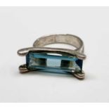 A silver ring set with an unusually wide rectangular aquamarine.Condition report: Ring size O