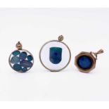 Three gold-mounted pendants, each containing opal behind glass 19.3gm