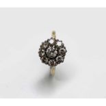 An 18ct gold ring set a bright nine stone diamond cluster totalling over 1ct 4gm