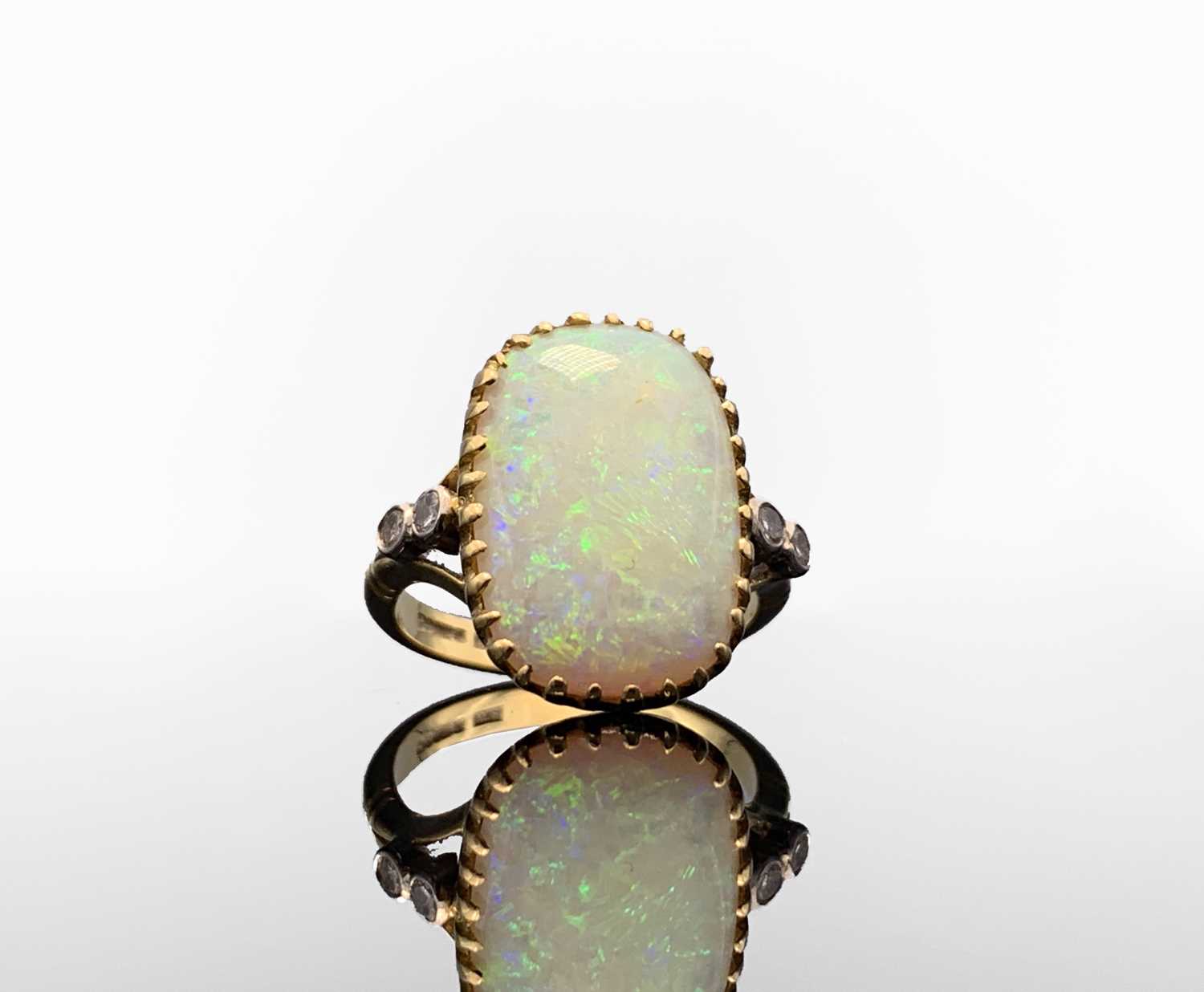 An 18ct gold ring set a large rounded rectangular opal, each shoulder set a pair of diamonds 7. - Image 3 of 4