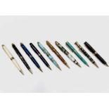 Ten ballpoint pens, each has gold plated mounts and a variety of tubes in wood and acrylic, One is