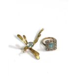 A very pretty square set gold ring, the central aquamarine surrounded by rose cut diamonds. Together