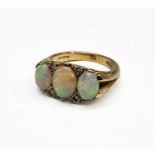 A 9ct gold Victorian style ring set three opals and small diamonds 5.4gmCondition report: central