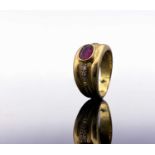 An 18ct broad ruby-set ring with diamond line shoulders 6.3gmCondition report: The ruby is of good