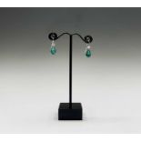 A pair of impressive emerald and diamond earrings, each has a pear shape emerald of about 2cts