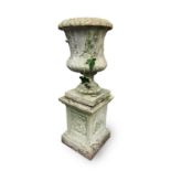 A reconstituted stone garden urn of campana form, raised on an associated square plinth base, both