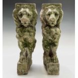 A pair of cast stone seated lion garden bench supports. Height 41cm.