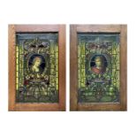 A pair of 19th century stained glass panels, centred with a male and a female portrait and each with
