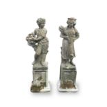 A pair of reconstituted stone garden statues, modelled as a male with a basket of grapes and a