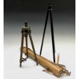 A surveyor's portable tripod, in leather case, appears unused, length 60cm, together with a brass