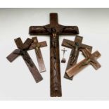 A rosewood and gilt metal mounted crucifix, circa 1920, height 25cm and five other crucifixes, of