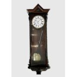 A late 19th century rosewood cased Vienna regulator type wall clock, with single weight, the