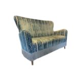 A 1950's Designer's Guild beech framed sofa, upholstered in Designer's Guild Royal Collection