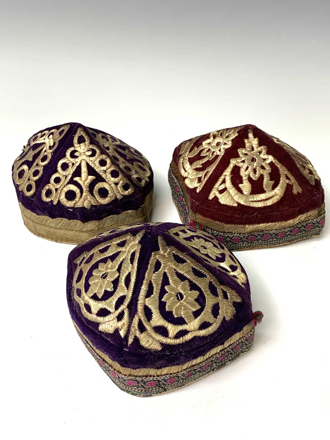 Three eastern skull caps, circa 1920, each embroidered and with gold thread decoration, together a - Image 12 of 13