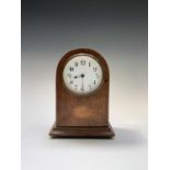 An Edwardian mahogany and inlaid dome top mantel timepiece, the dial with Arabic numerals, height