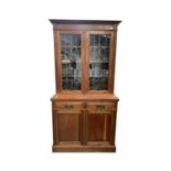 An Art nouveau walnut bookcase, with a pair of lead lined stained glass doors, height 205cm, width
