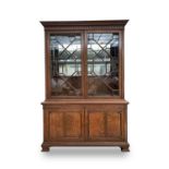 An oak glazed bookcase, early 20th century, with a pair of astragal glazed doors enclosing