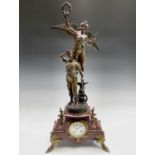 A French red marble clock, late 19th century, mounted with a spelter figure titled Gloire au
