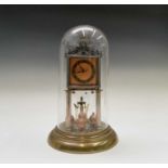 A Jahresuhrenfabrik brass torsion clock, 1920s, with Art Deco orange enamel decorated dial and