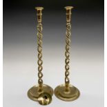 A tall pair of late Victorian brass barley twist candlesticks, with openwork stems and dished